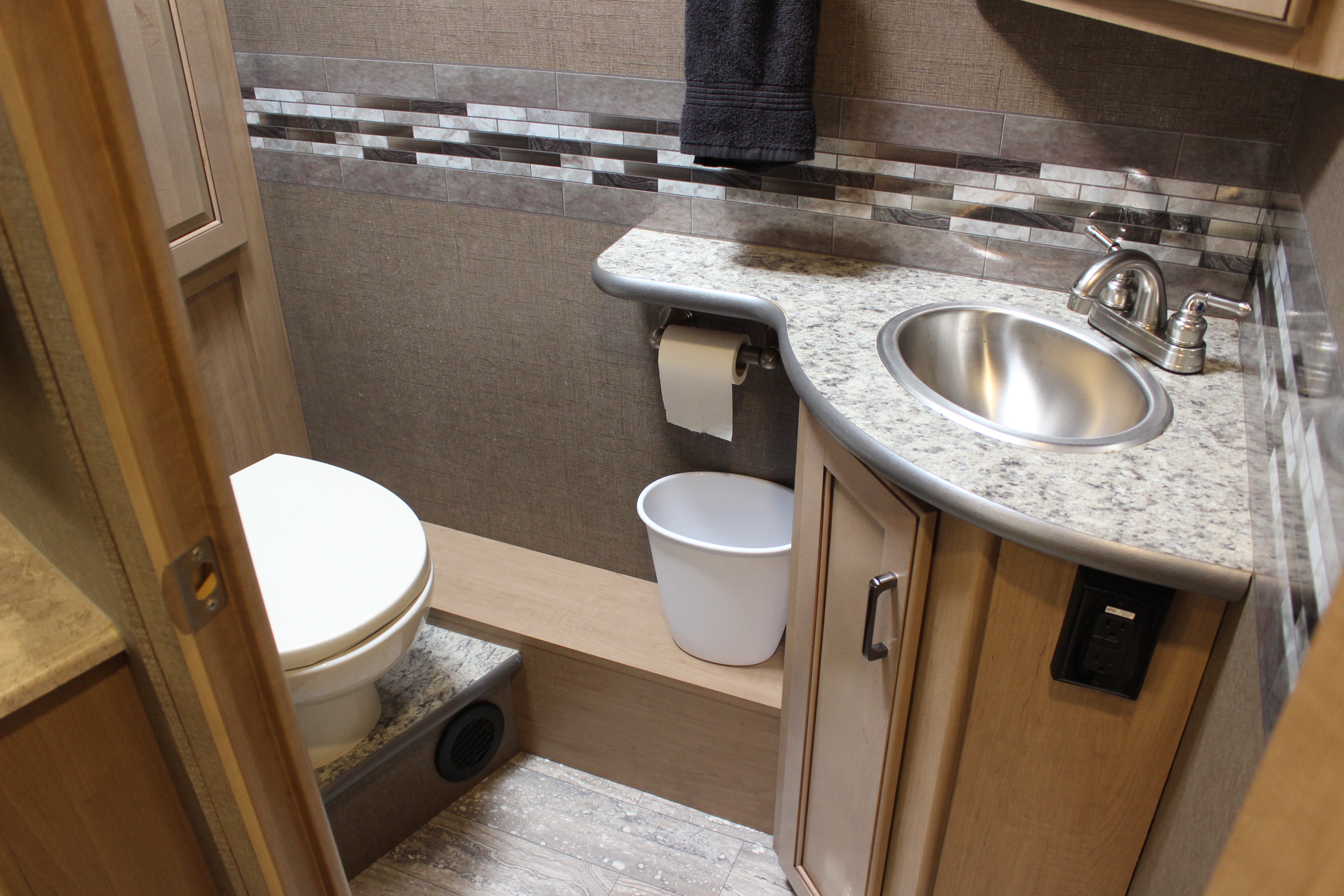 A half bathroom in an RV with toilet and sink